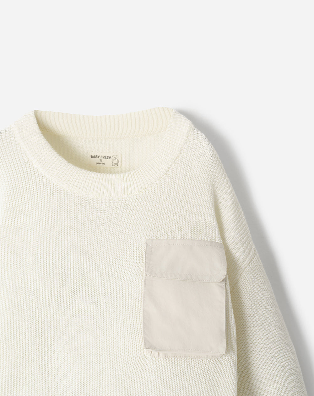 Buzo tejido crema niño