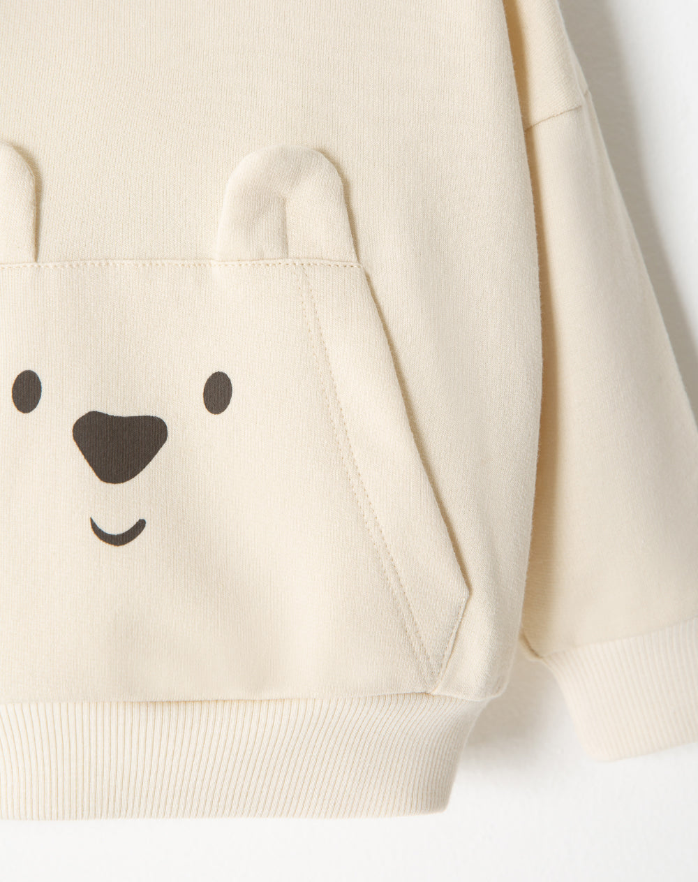 Buzo bolsillo canguro algodón crema bebé niño